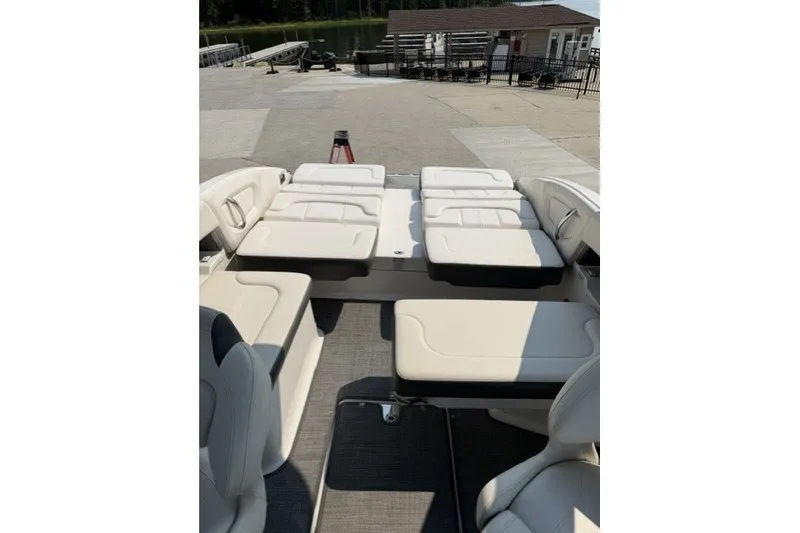 Slide: The Image of 2015 Chaparral 257 SSX boat interior with white seating and spacious layout. - 10