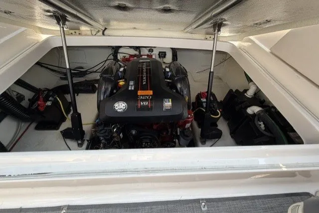 Slide: The Image of Engine compartment of a 2015 Chaparral 257 SSX boat, featuring a powerful V8 engine. - 12