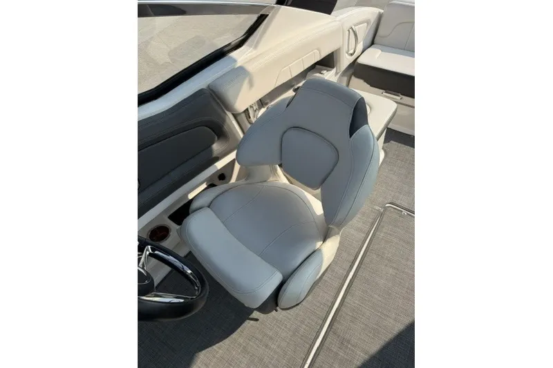 Slide: The Image of 2015 Chaparral 257 SSX boat interior with sleek, modern seating and steering wheel. - 6