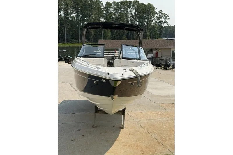 Slide: The Image of 2015 Chaparral 257 SSX boat on display, front view with trees in background. - 4