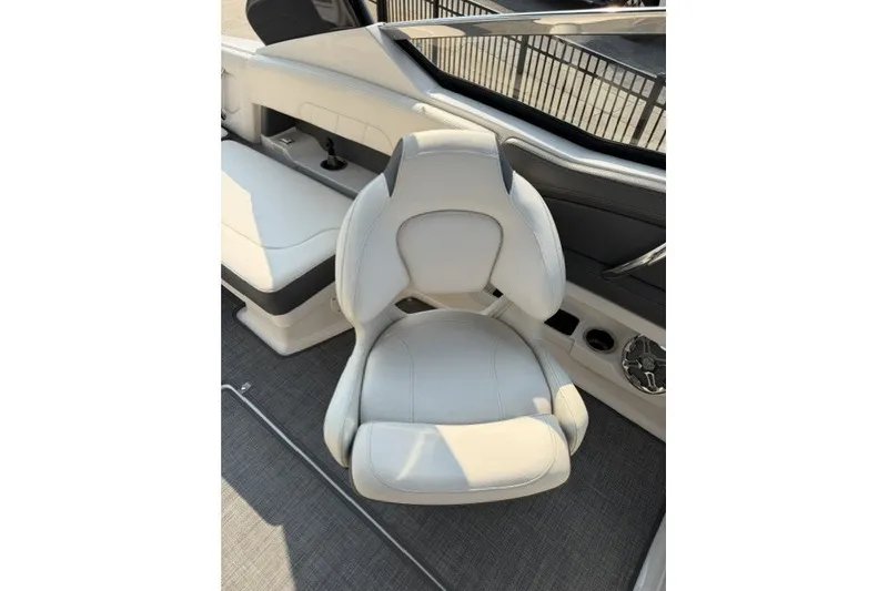 Slide: The Image of 2015 Chaparral 257 SSX boat interior with white captain's chair and sleek design. - 7