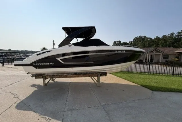 Slide: The Image of 2015 Chaparral 257 SSX boat displayed outdoors on a stand. - 17