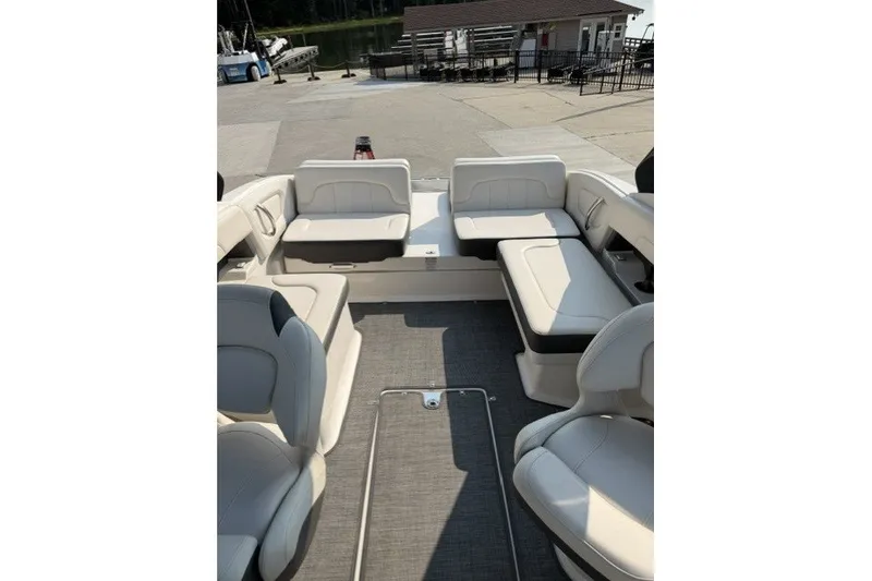 Slide: The Image of 2015 Chaparral 257 SSX boat interior with white seating and gray flooring. - 9