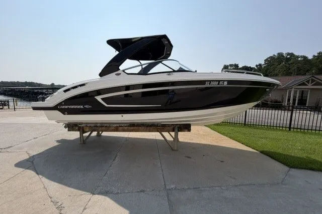 The Image of 2015 Chaparral 257 SSX boat on display, sleek design, black and white exterior. - 1