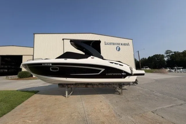 Slide: The Image of 2015 Chaparral 257 SSX boat at Lighthouse Marina, displayed on a stand. - 16