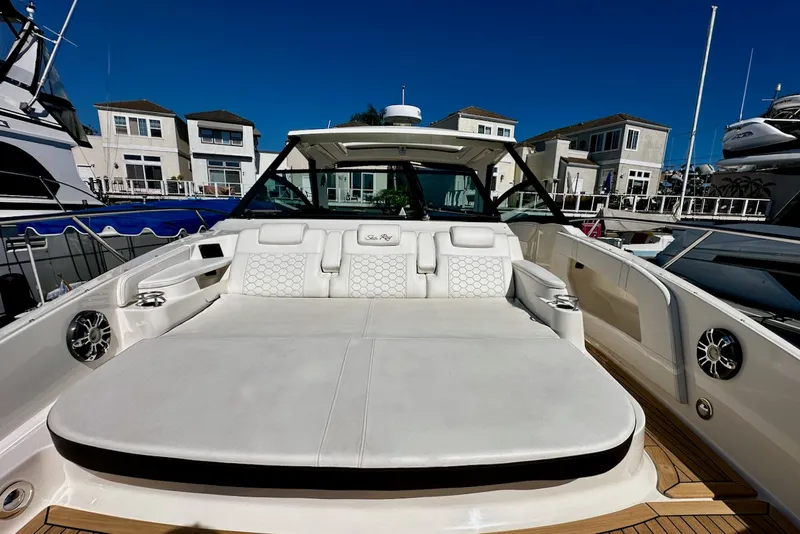 Slide: The Image of The image shows the spacious aft deck of a 2021 Sea Ray Sundancer 320 Outboard. - 25
