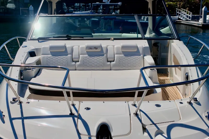 Slide: The Image of The image shows the cockpit of a 2021 Sea Ray Sundancer 320 Outboard with luxurious seating. - 8