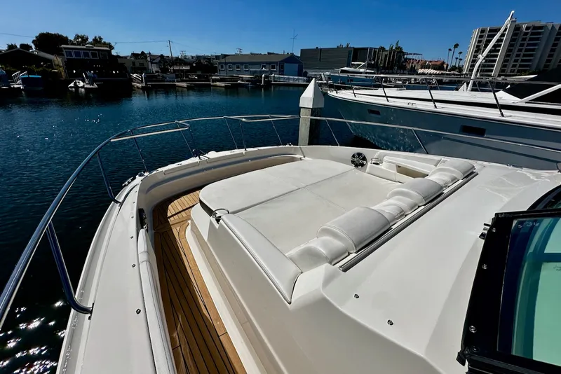 Slide: The Image of The image shows the foredeck of a 2021 Sea Ray Sundancer 320 Outboard with white cushions. - 24