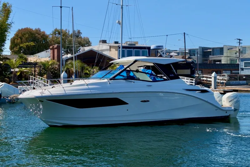 Slide: The Image of A sleek white motorboat floating on calm water in a harbor, surrounded by buildings. - 3