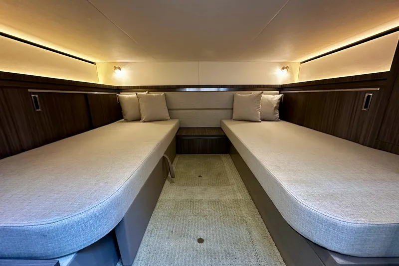 Slide: The Image of Interior of the 2021 Sea Ray Sundancer 320 Outboard with two single beds and elegant lighting. - 27