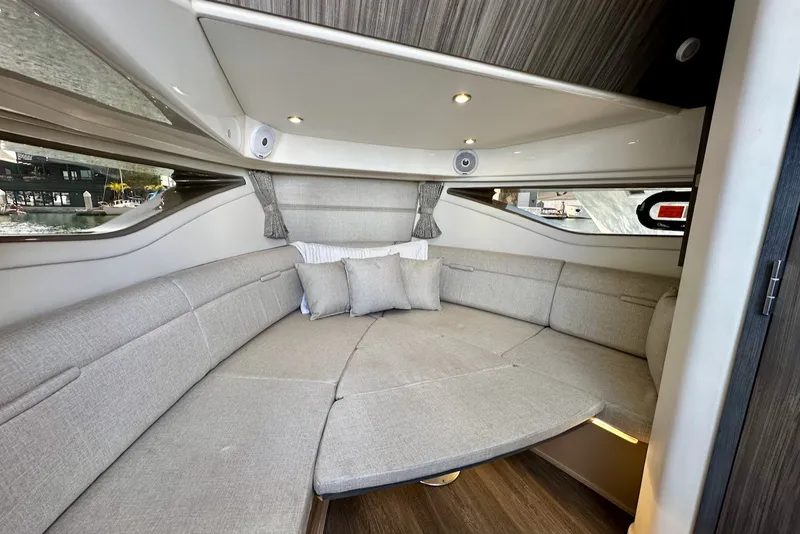 Slide: The Image of Interior of a 2021 Sea Ray Sundancer 320 Outboard with gray upholstery and windows. - 26