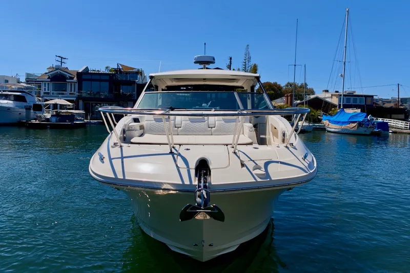 Slide: The Image of The 2021 Sea Ray Sundancer 320 Outboard is anchored in the water, surrounded by other boats. - 9