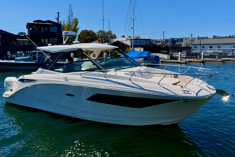 Slide: The Image of Sea Ray Sundancer 320 Outboard 2021 in a marina, featuring sleek design and spacious deck. - 4