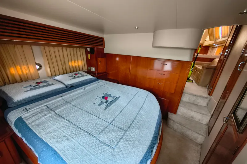 Slide: The Image of Luxurious bedroom interior of 2006 Carver 444 Cockpit Motor Yacht with elegant wood finish. - 31