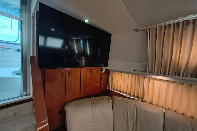 Slide: The Image of Interior of 2006 Carver 444 Cockpit Motor Yacht with TV and beige seating. - 24