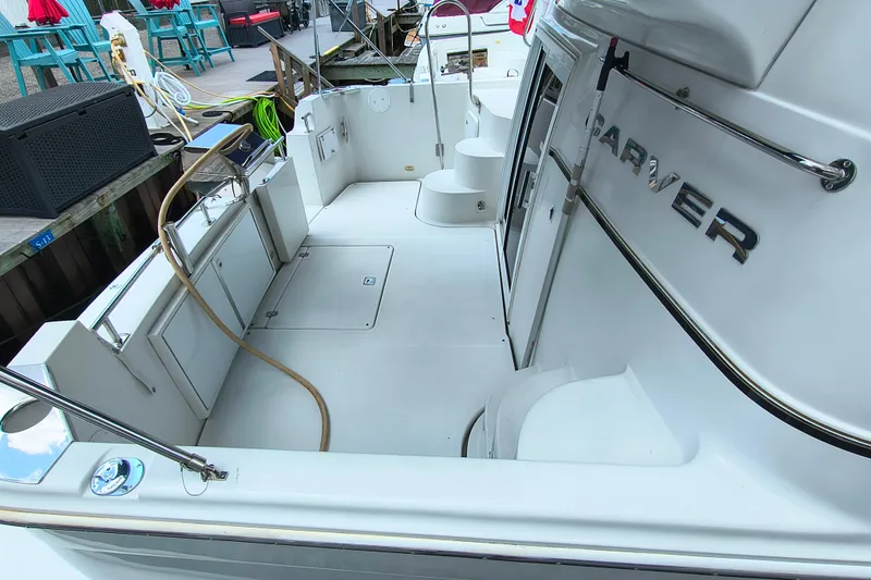 Slide: The Image of 2006 Carver 444 Cockpit Motor Yacht with spacious deck and sleek design. - 9
