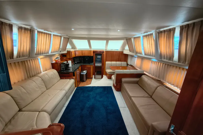 Slide: The Image of Luxurious interior of 2006 Carver 444 Cockpit Motor Yacht with plush seating and elegant decor. - 18