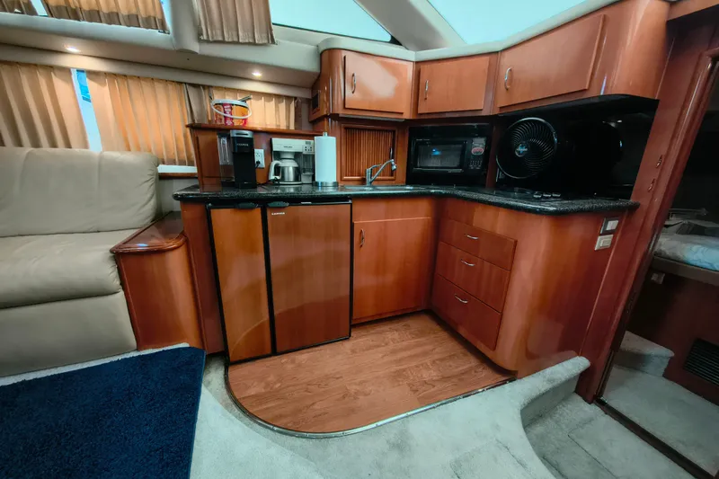 Slide: The Image of Luxurious 2006 Carver 444 Cockpit Motor Yacht interior with modern kitchen amenities. - 23