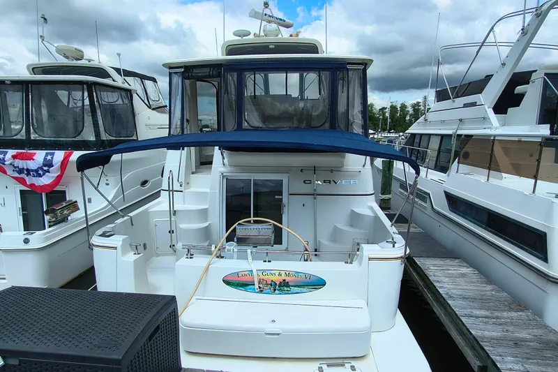 Slide: The Image of 2006 Carver 444 Cockpit Motor Yacht docked at marina under cloudy sky. - 8