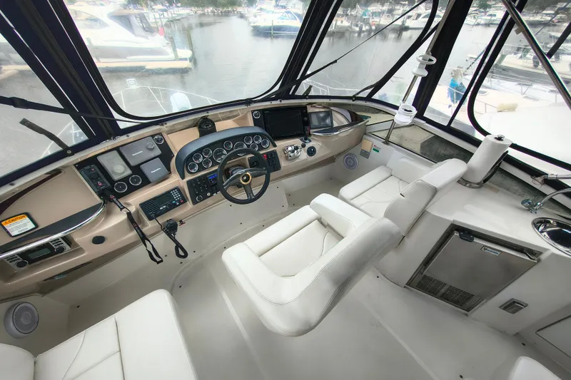 Slide: The Image of Cockpit of 2006 Carver 444 Cockpit Motor Yacht with steering wheel and control panels. - 16