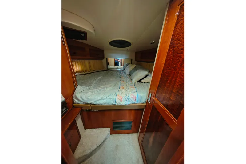 Slide: The Image of Luxurious bedroom interior of 2006 Carver 444 Cockpit Motor Yacht with wood finishes. - 26