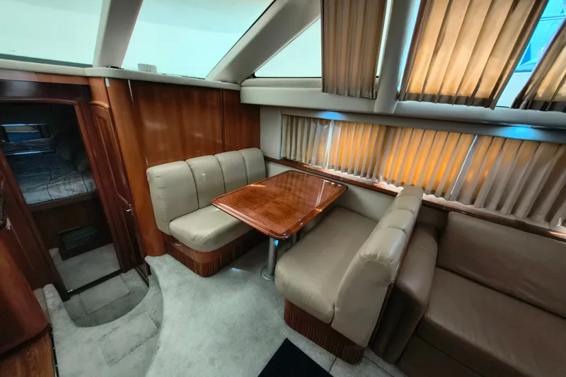 Slide: The Image of Interior of 2006 Carver 444 Cockpit Motor Yacht with dining area and seating. - 22