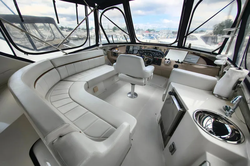 Slide: The Image of Luxurious interior of 2006 Carver 444 Cockpit Motor Yacht with plush seating and modern helm. - 14