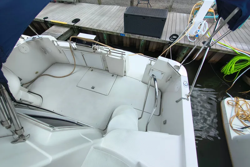 Slide: The Image of 2006 Carver 444 Cockpit Motor Yacht docked, showcasing spacious cockpit and clean design. - 10
