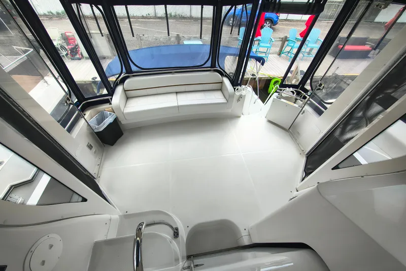 Slide: The Image of 2006 Carver 444 Cockpit Motor Yacht interior with spacious seating and panoramic windows. - 13