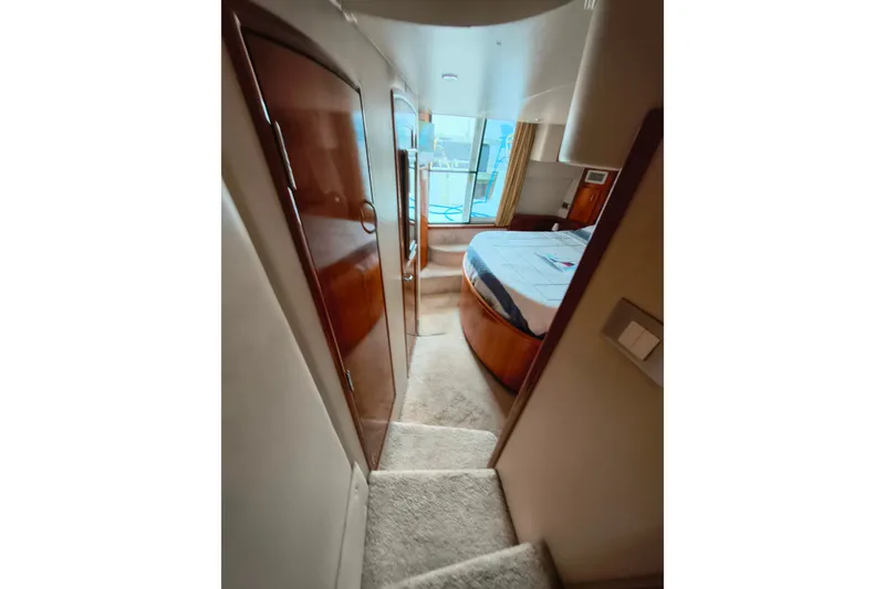 Slide: The Image of Interior view of 2006 Carver 444 Cockpit Motor Yacht bedroom with wooden finishes. - 28