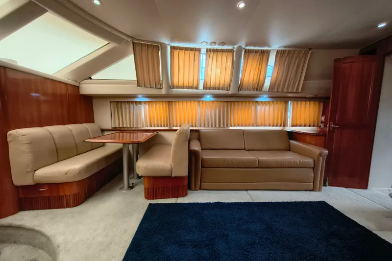 Slide: The Image of Luxurious interior of 2006 Carver 444 Cockpit Motor Yacht with plush seating and elegant wood finishes. - 21