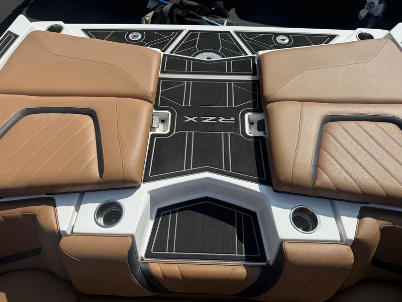 Slide: The Image of The image shows the stern of a 2022 Tigé 20 RZX with brown upholstery and black accents. - 37