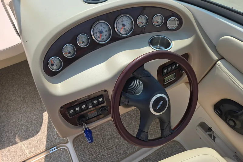 Slide: The Image of 2006 Chaparral 220 SSi boat dashboard with gauges and steering wheel. - 15