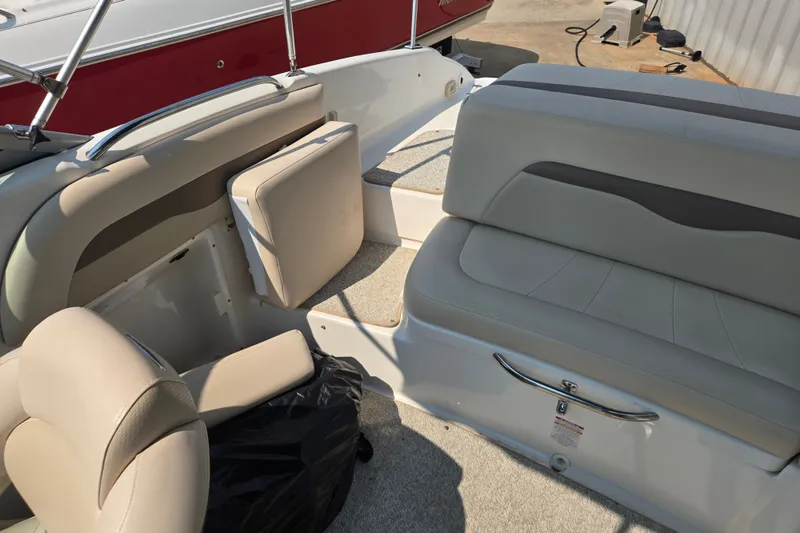Slide: The Image of Interior of a 2006 Chaparral 220 SSi boat with beige seating and storage compartments. - 19