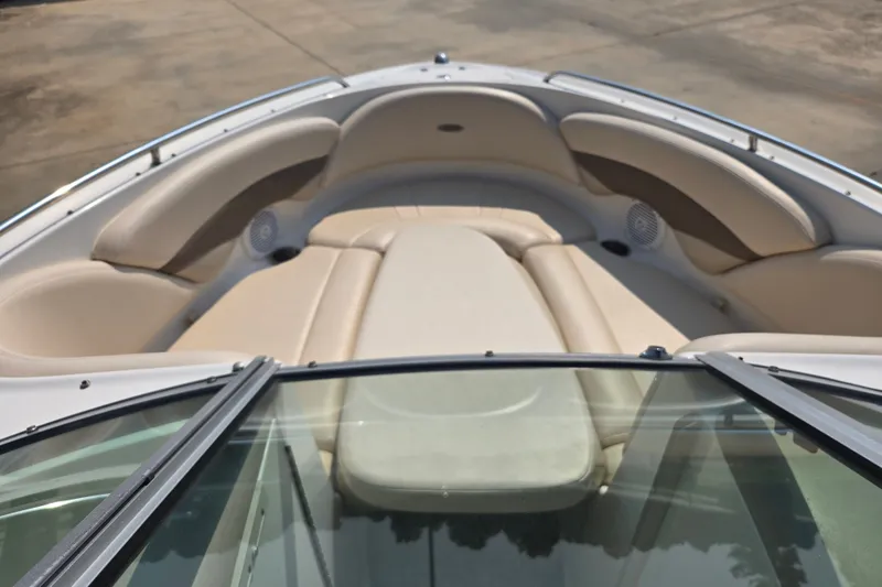 Slide: The Image of 2006 Chaparral 220 SSi boat interior with beige seating and speakers. - 14
