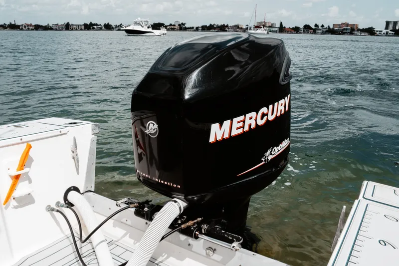 Slide: The Image of Outboard motor on a 1996 Mako 231 Center Console boat in a scenic waterway. - 15