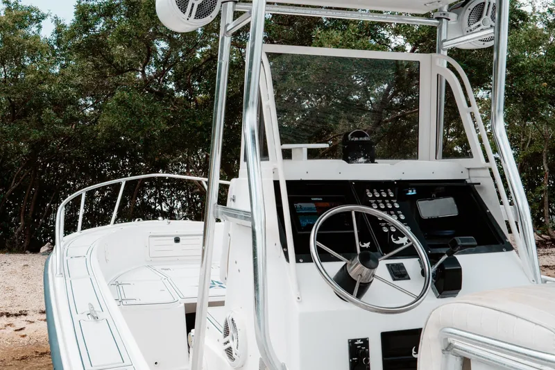 Slide: The Image of 1996 Mako 231 Center Console boat with steering wheel and control panel. - 5