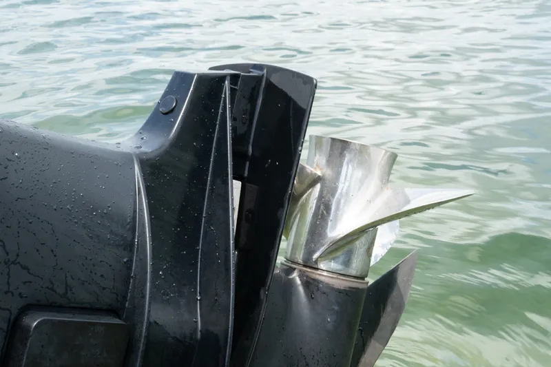 Slide: The Image of Close-up of a boat propeller on a 1996 Mako 231 Center Console in water. - 21