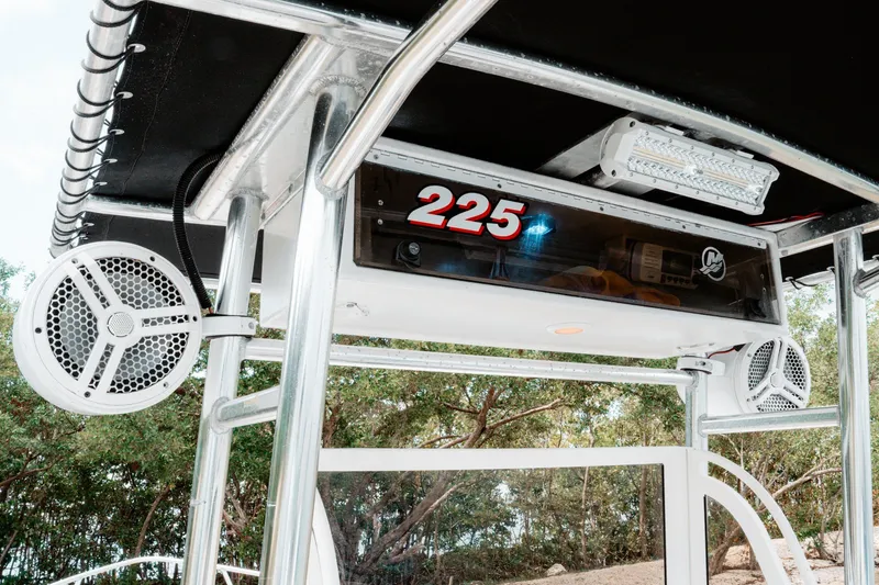 Slide: The Image of 1996 Mako 231 Center Console boat with speakers and LED lights on T-top. - 9
