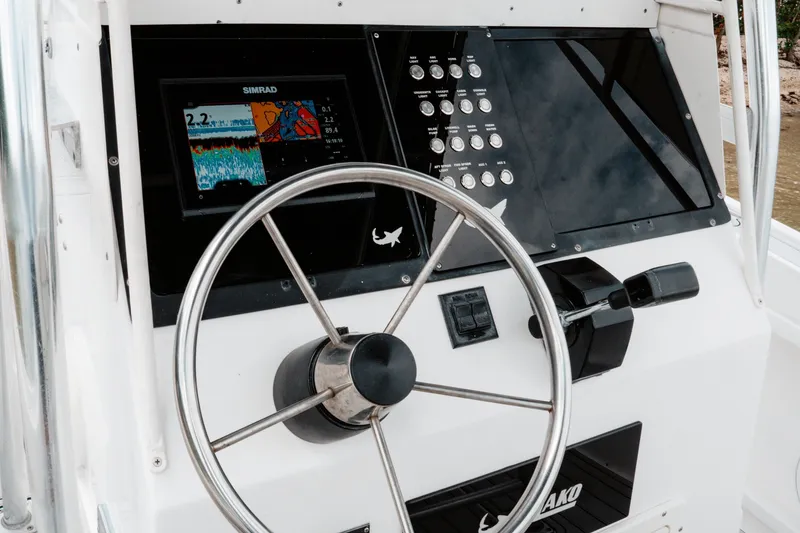 Slide: The Image of Steering console of a 1996 Mako 231 Center Console boat with navigation display. - 7