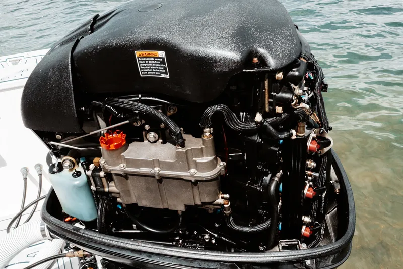 Slide: The Image of Outboard motor of a 1996 Mako 231 Center Console boat on water. - 16