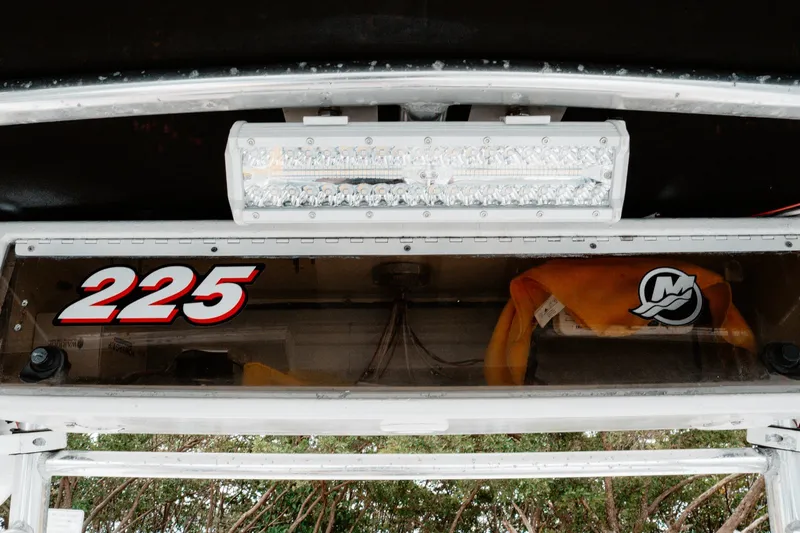 Slide: The Image of Close-up of a 1996 Mako 231 Center Console boat dashboard with "225" decal and LED light. - 10