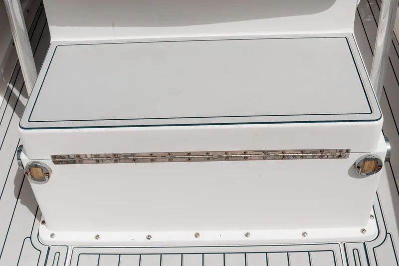 Slide: The Image of 1996 Mako 231 Center Console boat seating with storage compartment. - 35