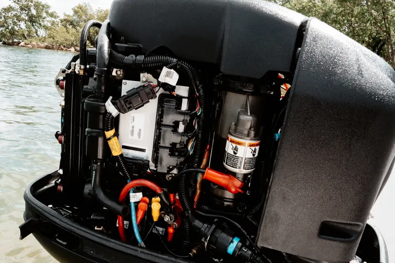 Slide: The Image of Close-up of a 1996 Mako 231 Center Console boat engine, showcasing intricate wiring and components. - 18