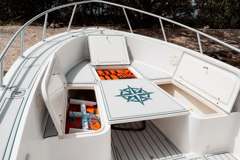Slide: The Image of 1996 Mako 231 Center Console boat with open storage compartments and safety gear. - 27