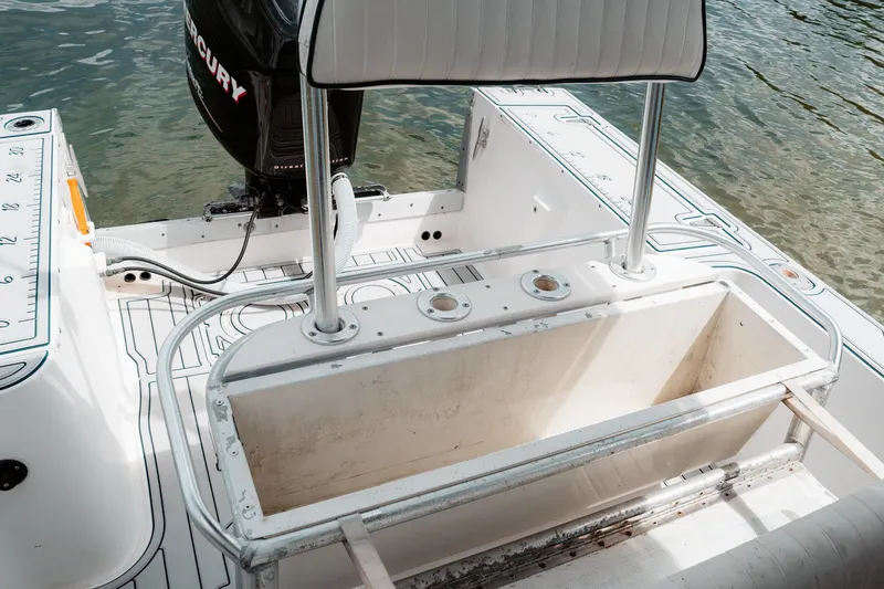 Slide: The Image of 1996 Mako 231 Center Console boat interior with Mercury engine, featuring rod holders and seating. - 40