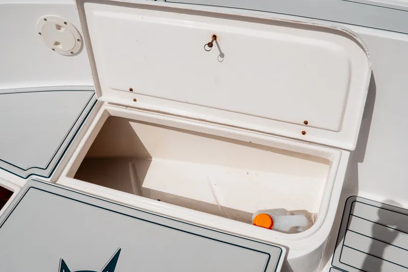 Slide: The Image of Open storage compartment on a 1996 Mako 231 Center Console boat. - 29
