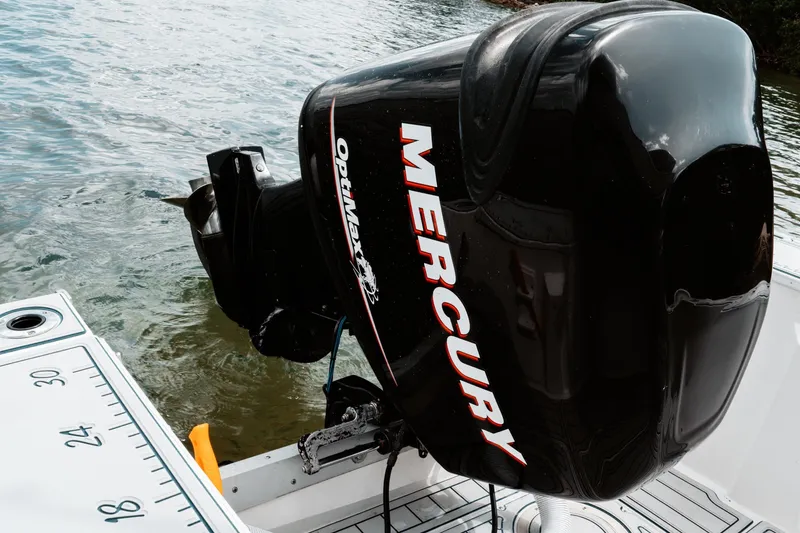 Slide: The Image of Outboard motor on 1996 Mako 231 Center Console boat, featuring Mercury OptiMax engine. - 19