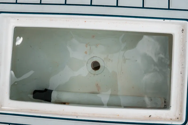 Slide: The Image of Livewell in a 1996 Mako 231 Center Console boat, partially filled with water. - 42