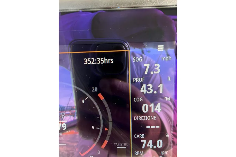 Slide: The Image of Display screen showing boat metrics: speed 7.3 mph, depth 43.1 ft, 352 hours logged. - 12